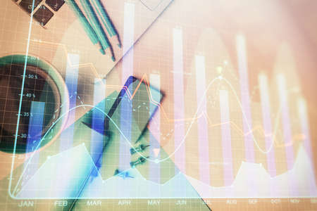 Double exposure of forex graph drawing over desktop background with computer. Concept of financial...