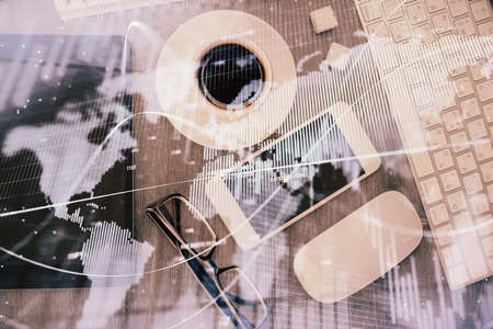 Multi exposure of forex graph hologram over desktop with phone. Top view. Mobile trade platform...
