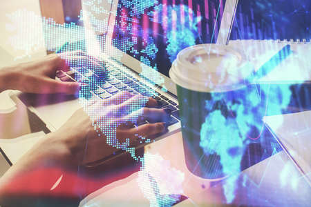 Double exposure of woman hands typing on computer and forex chart hologram drawing. Stock market invest concept.の写真素材