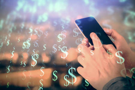 Double exposure of mans hands holding and using a digital device and forex graph drawing. Financial market concept.の写真素材