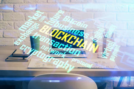 Double exposure of blockchain theme hologram and table with computer background. Concept of bitcoin crypto currency.の写真素材