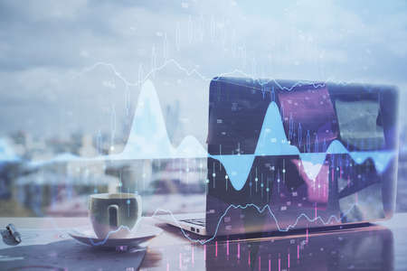 Stock market graph and table with computer background. Multi exposure. Concept of financial...