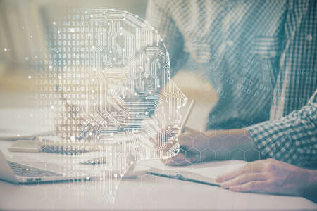Man typing on keyboard background with brain hologram. Concept of big Data.の写真素材