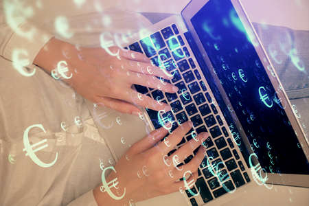 Double exposure of woman hands working on computer and forex chart hologram drawing. Top View. Financial analysis concept.の写真素材