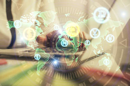 Double exposure of businesswoman hands typing on computer and financial graph hologram drawing....