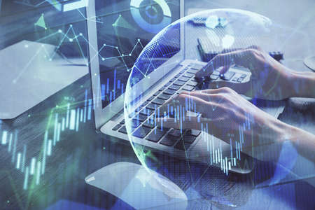 Double exposure of woman hands typing on computer and forex chart hologram drawing. Stock market...