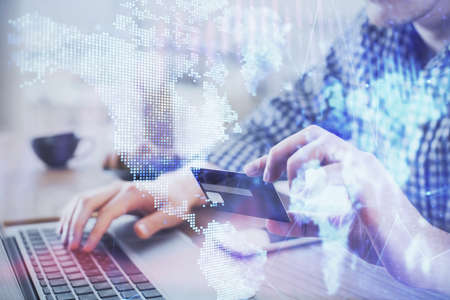 Double exposure of man hands holding a credit card and Forex graph drawing. Stock trading and digital fintech in Internet E-commerce concept.の写真素材