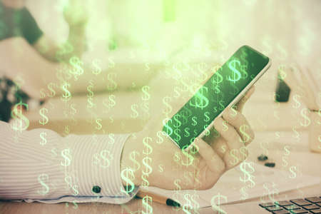 Double exposure of mans hands holding and using a digital device and forex graph drawing. Financial...