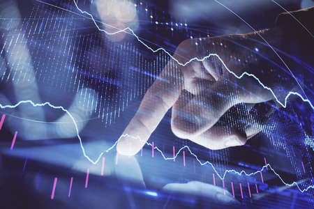 Multi exposure of mans hands holding and using a phone and financial chart drawing. Market analysis...