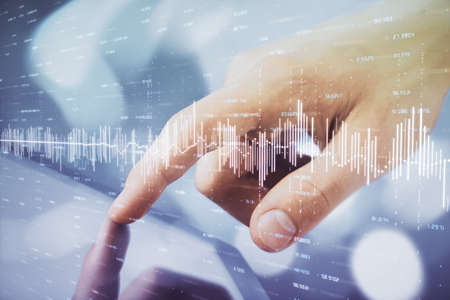 Multi exposure of mans hands holding and using a phone and financial chart drawing. Market analysis...