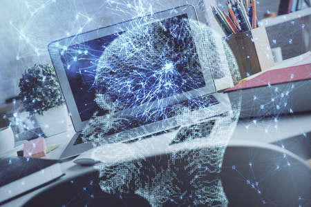 Double exposure of work space with computer and human brain drawing hologram. Brainstorm concept.