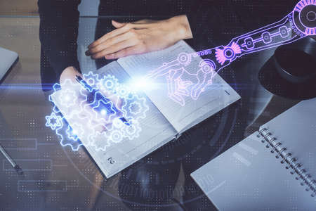Double exposure of writing hands on background with data solution hologram on front. Technology...