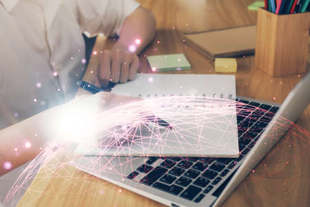 Social network theme hologram over womans hands writing background. Concept of international people connect. Double exposureの写真素材