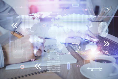 Multi exposure of world map hologram with man working on computer on background. Concept of worldwideweb.の写真素材