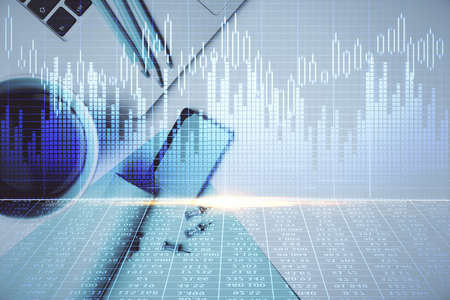 Double exposure of forex graph drawing over desktop background with computer. Concept of financial...