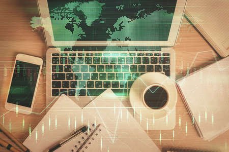 Stock market chart and top view computer on the table background. Double exposure. Concept of...