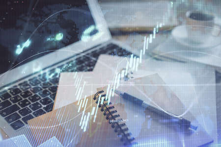 Double exposure of financial chart drawing and desktop with coffee and items on table background....
