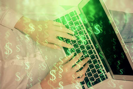 Double exposure of woman hands working on computer and forex chart hologram drawing. Top View. Financial analysis concept.の写真素材