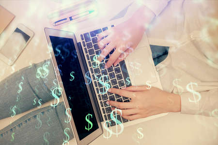 Double exposure of woman hands working on computer and forex graph hologram drawing. Top View....
