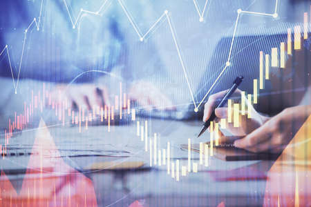 Multi exposure of woman hands typing on computer and forex chart hologram drawing. Stock market...
