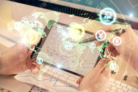 Double exposure of mans hands holding and using a phone and financial chart drawing. Market analysis...