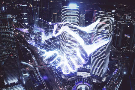 Double exposure of handshake hologram over city view background. Concept of partnership.