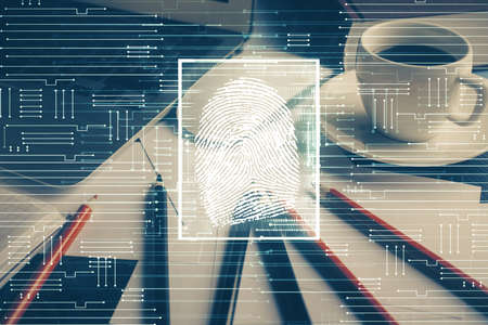 Computer on desktop in office with finger print drawing. Double exposure. Concept of business data security.の写真素材