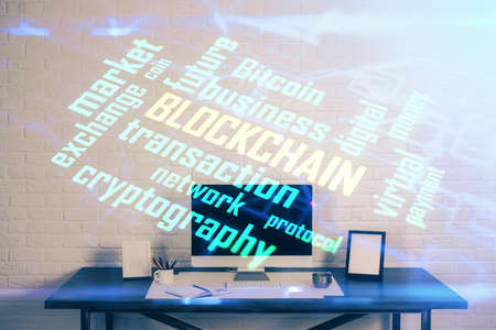 Double exposure of blockchain theme hologram and table with computer background. Concept of bitcoin crypto currency.の写真素材