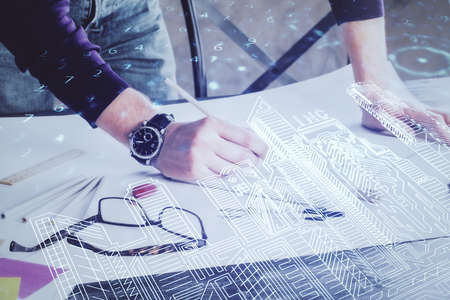 Abstract holographic city on mans hand writing notes background. Double exposure.の写真素材