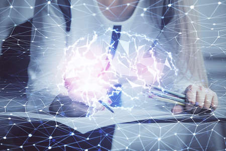 Multi exposure of womans writing hand on background with brain hud. Concept of learning.