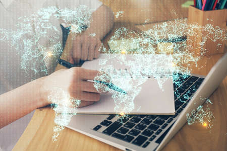 Social network theme hologram over womans hands writing background. Concept of international people connect. Double exposureの写真素材