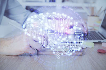 Man typing on keyboard background with brain hologram. Concept of big Data. Double exposure.の写真素材