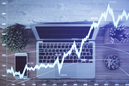Multi exposure of financial chart drawing over table background with computer. Concept of research...