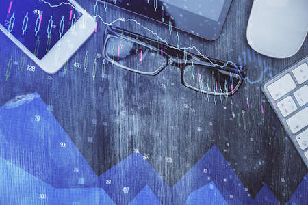 Multi exposure of forex graph hologram over desktop with phone. Top view. Mobile trade platform concept.の写真素材