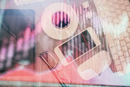 Multi exposure of forex graph hologram over desktop with phone. Top view. Mobile trade platform...