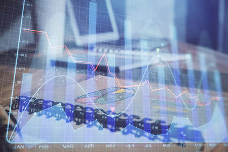 Double exposure of financial graph drawings and desk with open notebook background. Concept of forex...
