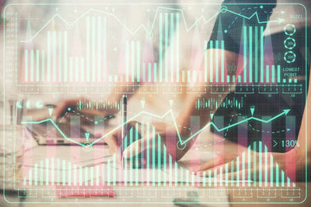 Multi exposure of woman hands typing on computer and financial chart hologram drawing. Stock market...