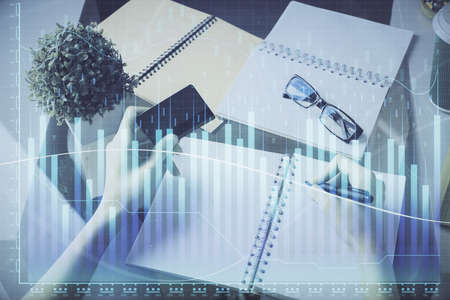 Multi exposure of woman on-line shopping holding a credit card and financial graph drawing. Stock...