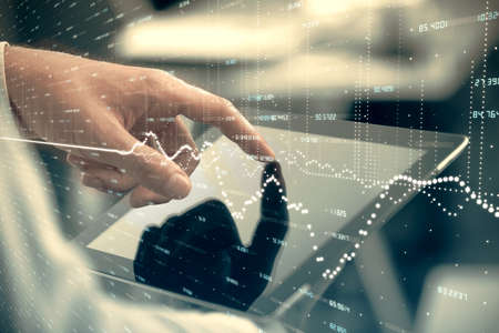 Multi exposure of mans hands holding and using a phone and financial chart drawing. Market analysis...