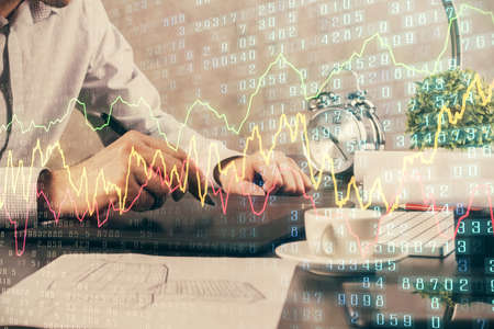 Double exposure of mans hands holding and using a phone and financial graph drawing. Analysis...