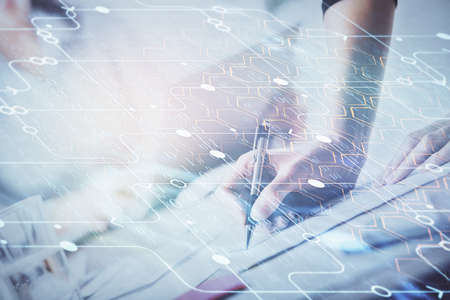 Double exposure of womans writing hand on background with data technology hud. Big data concept.