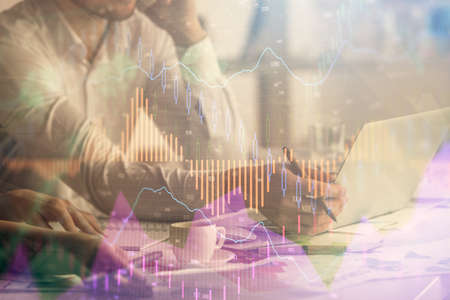 Multi exposure of man and woman working together and financial chart hologram. Business concept....