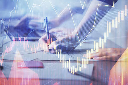 Multi exposure of woman hands typing on computer and financial chart hologram drawing. Stock market...