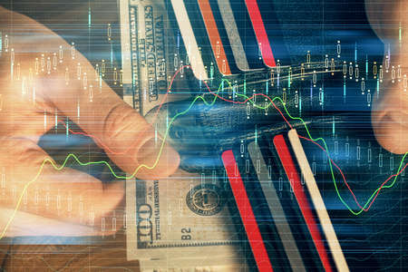 Multi exposure of forex graph drawing hologram and USA dollars bills and man hands. Technical Analysis concept.の写真素材