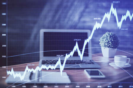 Forex market graph hologram and personal computer on background. Multi exposure. Concept of...