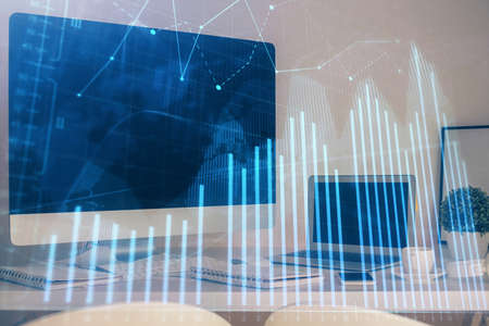 Stock market graph and table with computer background. Double exposure. Concept of financial...