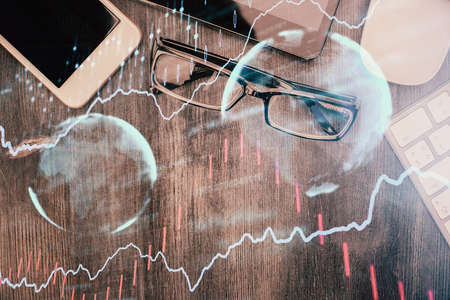 Multi exposure of forex graph hologram over desktop with phone. Top view. Mobile trade platform concept.の写真素材