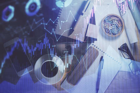 Double exposure of forex graph drawing and work table top veiw. Concept of financial analysis.