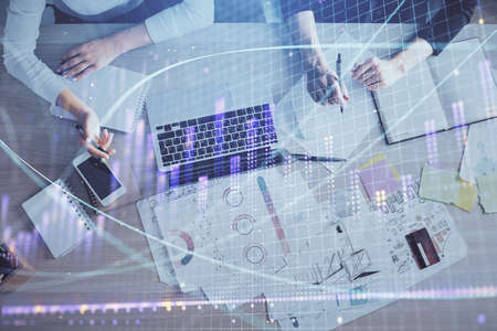 Double exposure of woman hands working on computer and forex graph hologram drawing. Top View....