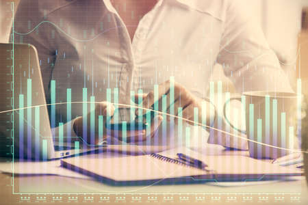 Double exposure of forex chart sketch hologram and woman holding and using a mobile device....
